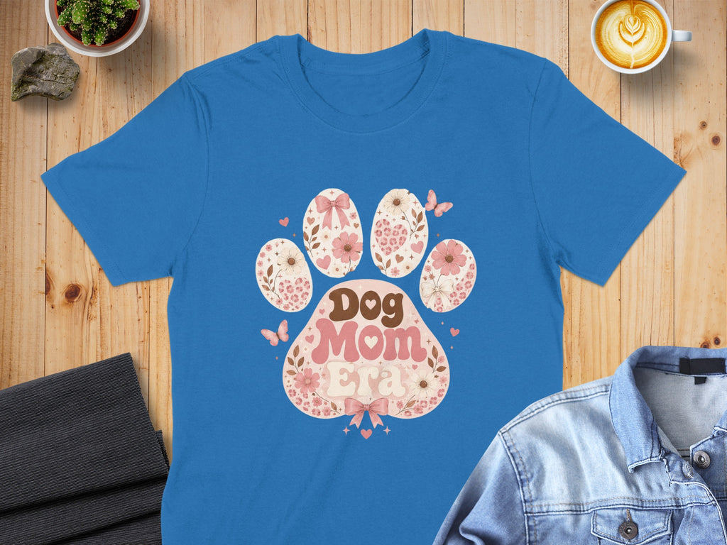 Blue t-shirt featuring a paw print graphic with "Dog Mom Era" in retro font.
