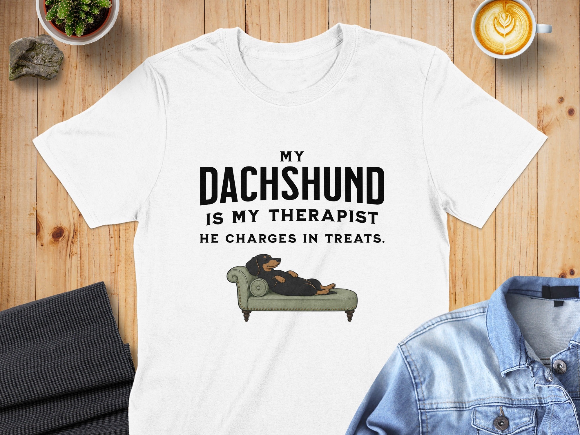 White t-shirt with "My Dachshund is My Therapist He Charges in Treats" text and illustration.
