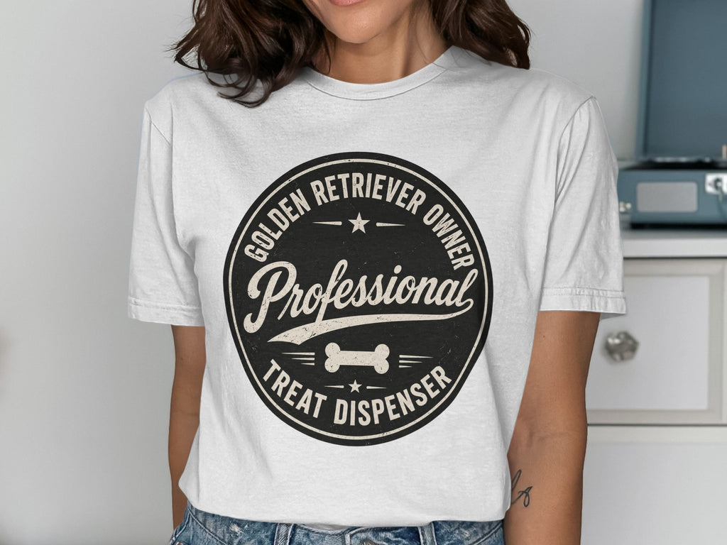 White t-shirt with a circular black graphic that says "Professional Golden Retriever Owner Treat Dispenser".