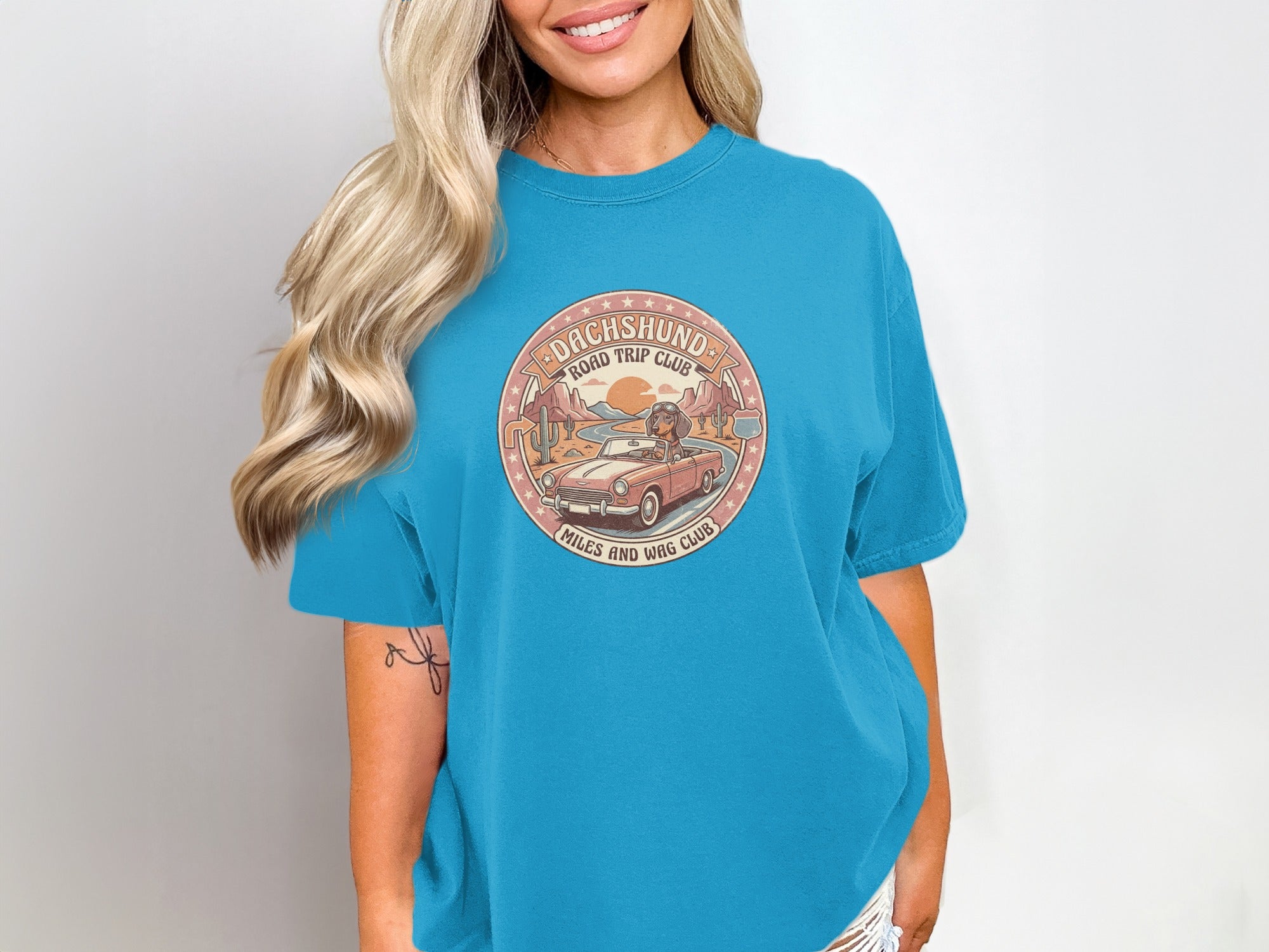 Dachshund road trip club graphic on blue t-shirt.