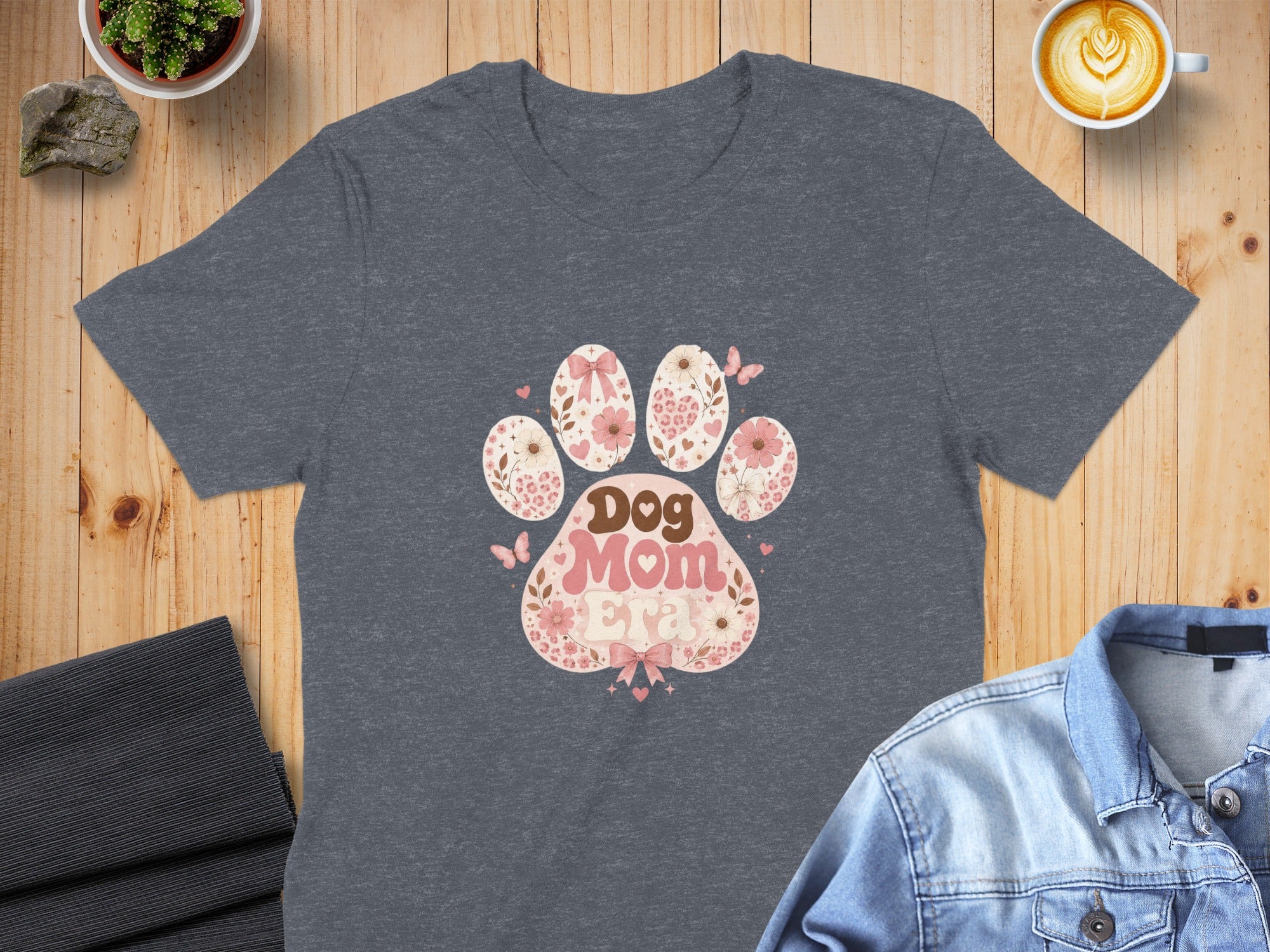 Dark gray t-shirt with a pink floral dog paw print graphic and the words "Dog Mom".
