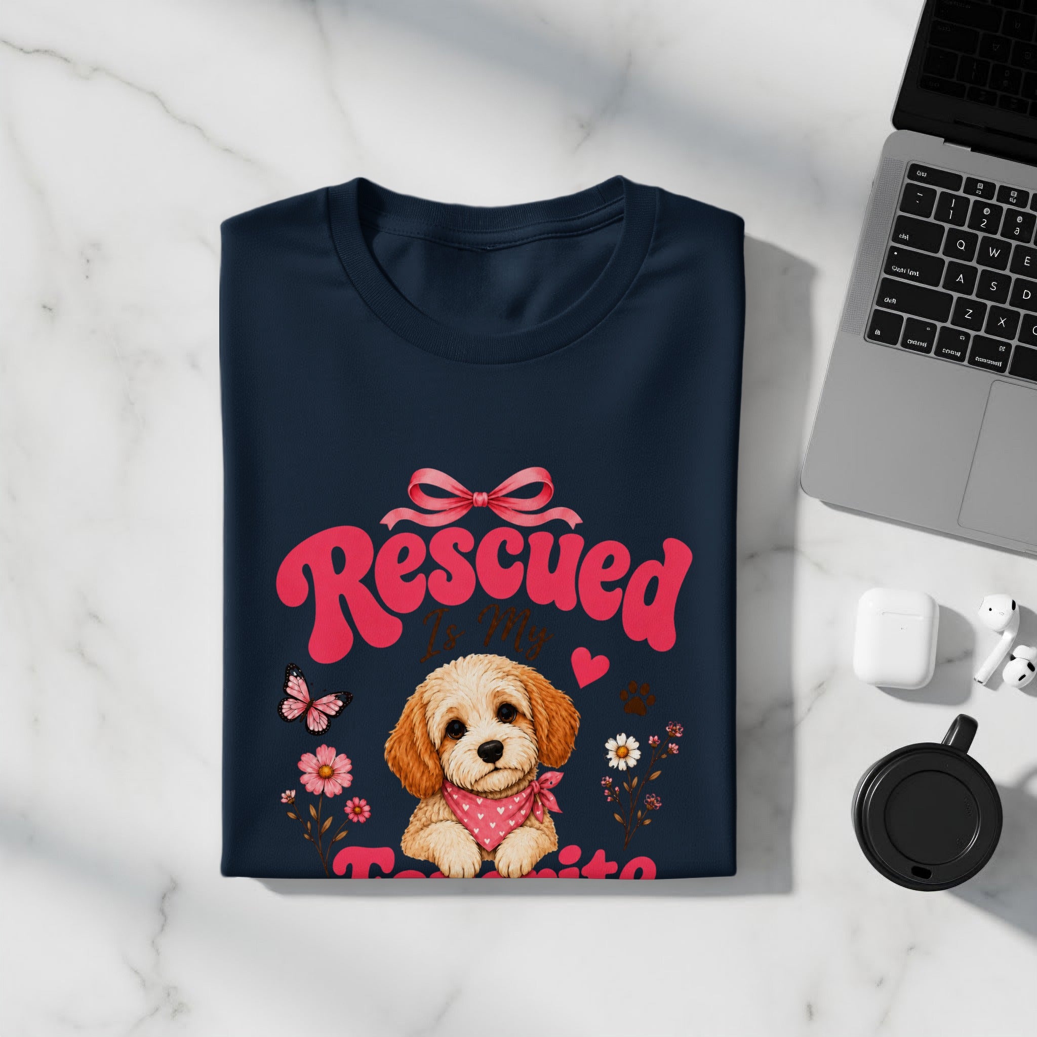 Dark blue t-shirt with a rescued puppy design, pink text "Rescued" and flowers.