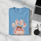 Light blue t-shirt with "Dog Mom Era" text and floral paw print design.