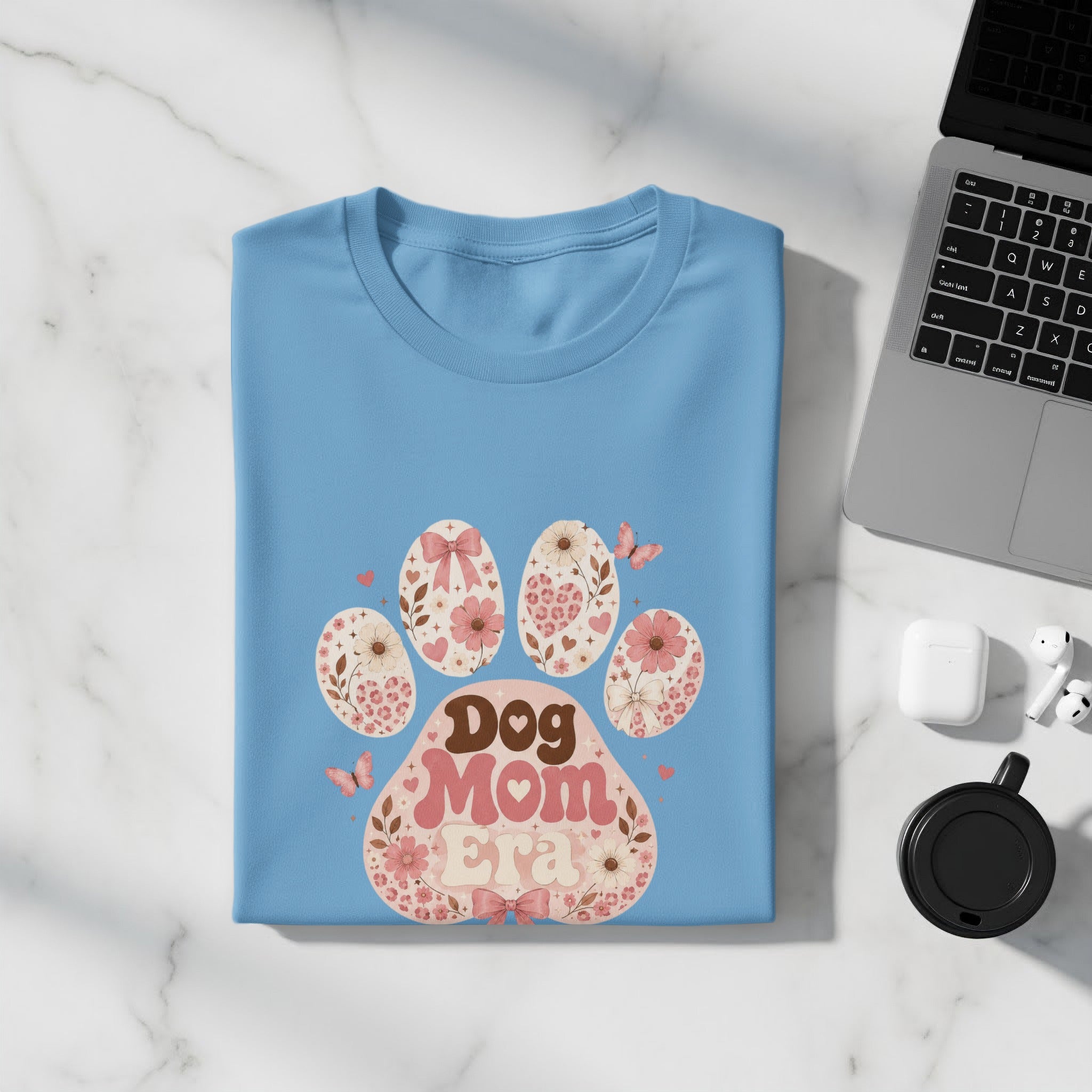 Light blue t-shirt with "Dog Mom Era" text and floral paw print design.