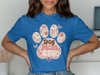 Blue t-shirt with a floral paw print design that reads "Dog Mom Era".