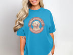 Golden Retriever Club graphic on a teal t-shirt.