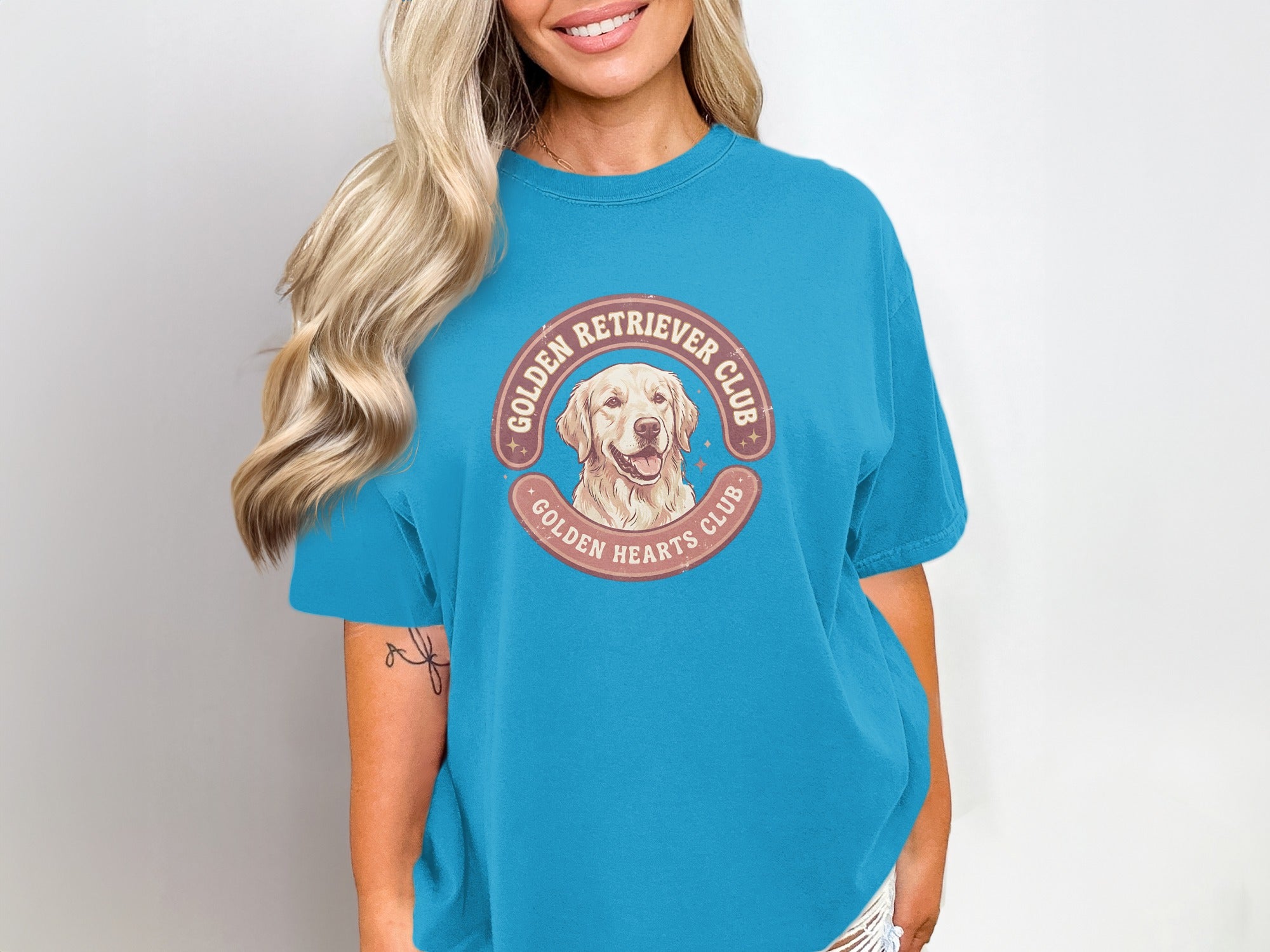 Golden Retriever Club graphic on a teal t-shirt.