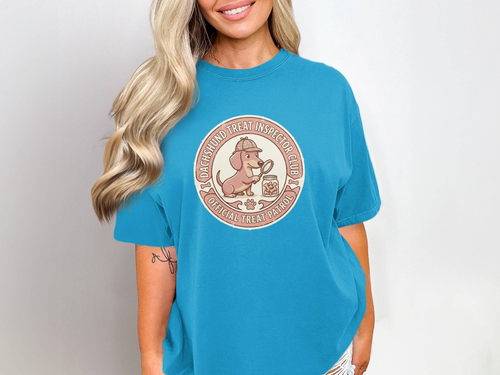 Dachshund Treat Inspector Club Official Treat Patrol logo on a blue t-shirt.