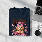 Navy t-shirt with a graphic of a dog, pink bow, butterflies, flowers, and text "Sorry, I Have Plans".