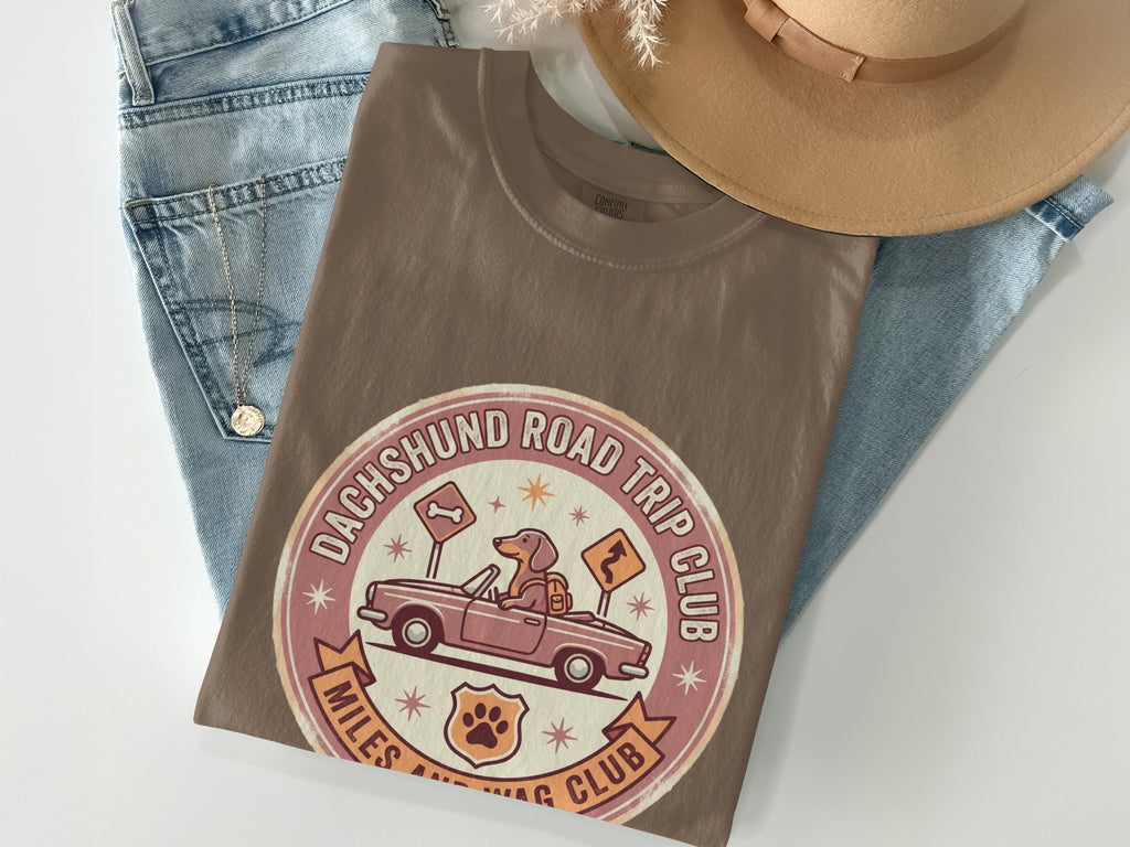 Brown t-shirt with Dachshund Road Trip Club logo featuring a dog driving a car.