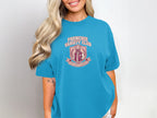 Frenchie Varsity Club logo on a teal t-shirt.