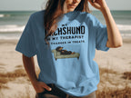 Light blue t-shirt with text "My Dachshund is my therapist" and illustration of a dachshund on a couch.