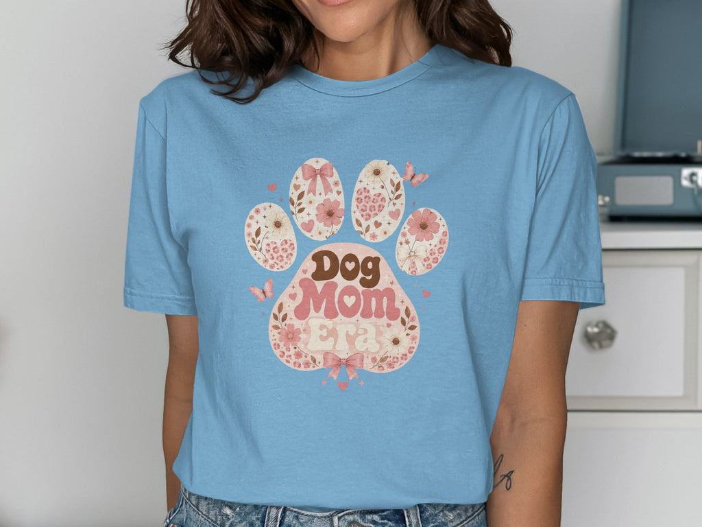 T-shirt with a paw print design featuring "Dog Mom" text and floral elements.