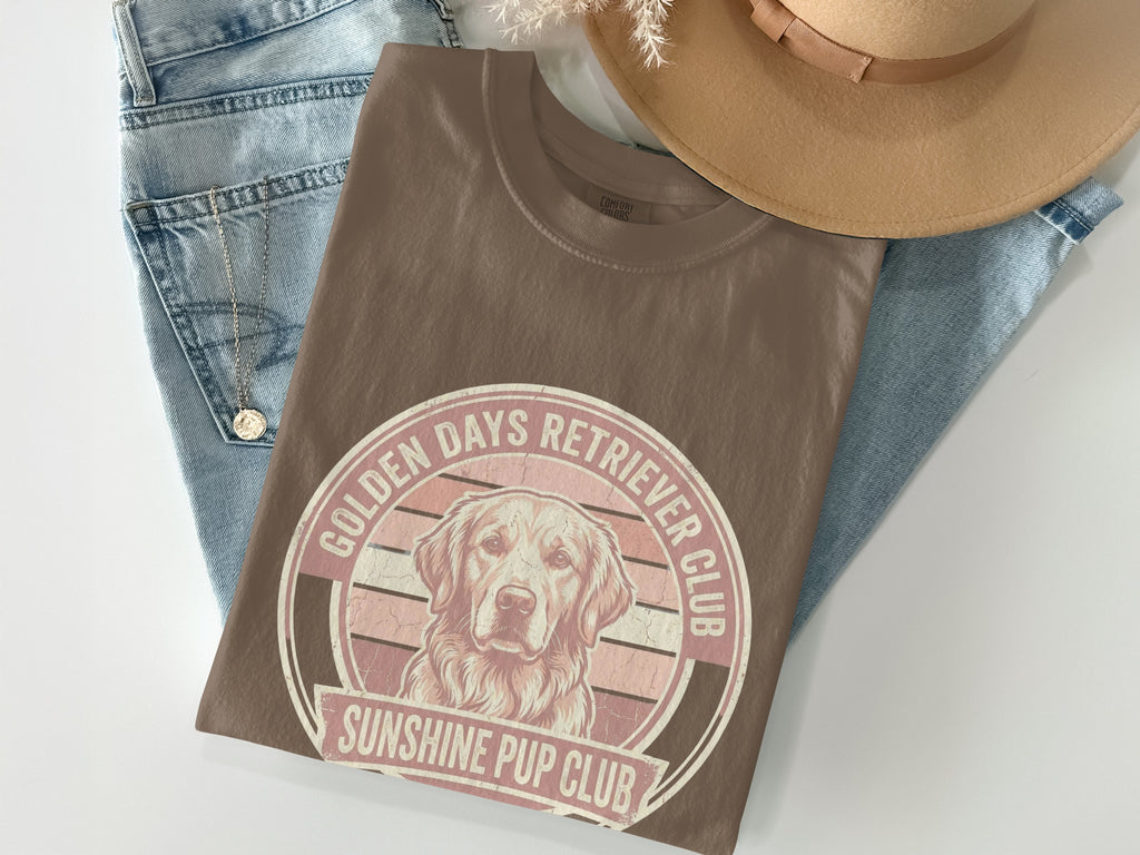 Brown t-shirt with "Golden Days Retriever Club Sunshine Pup Club" text and dog graphic.