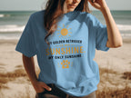 Light blue t-shirt with text "My Golden Retriever is my sunshine, my only sunshine" and paw print.
