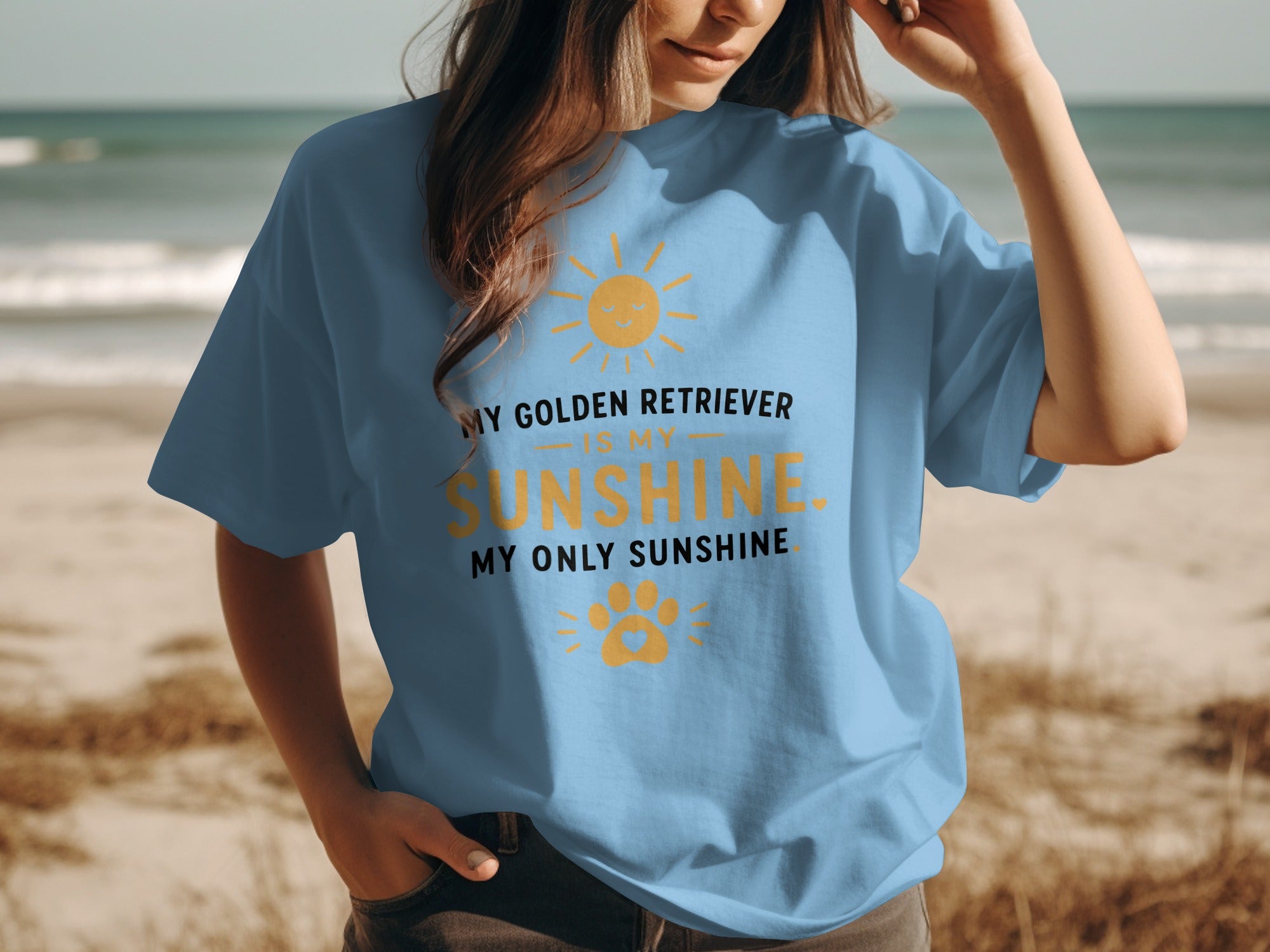 Light blue t-shirt with text "My Golden Retriever is my sunshine, my only sunshine" and paw print.