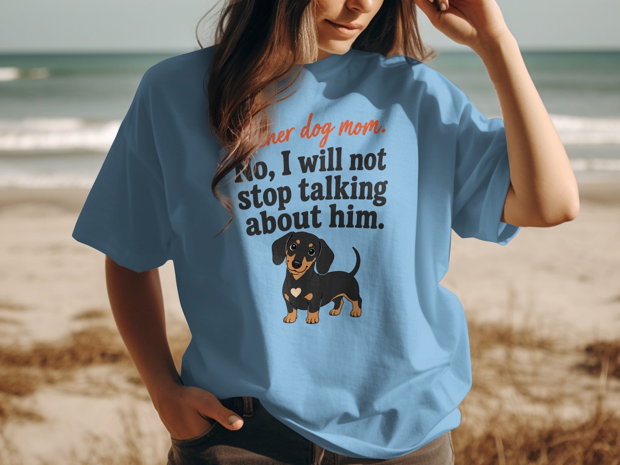 Light blue t-shirt with "Another dog mom. No, I will not stop talking about him." and a dachshund.