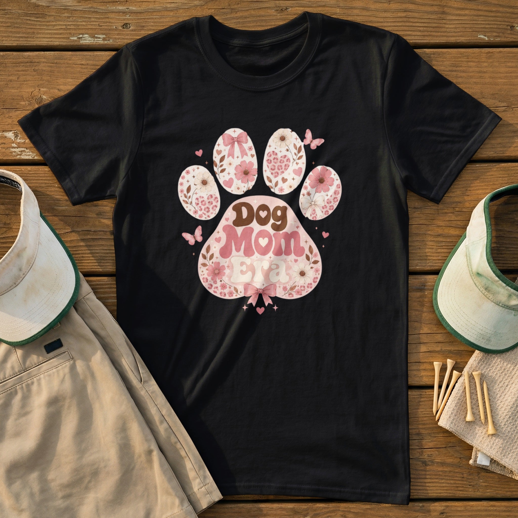 Black t-shirt with "Dog Mom Era" text in a paw print design.