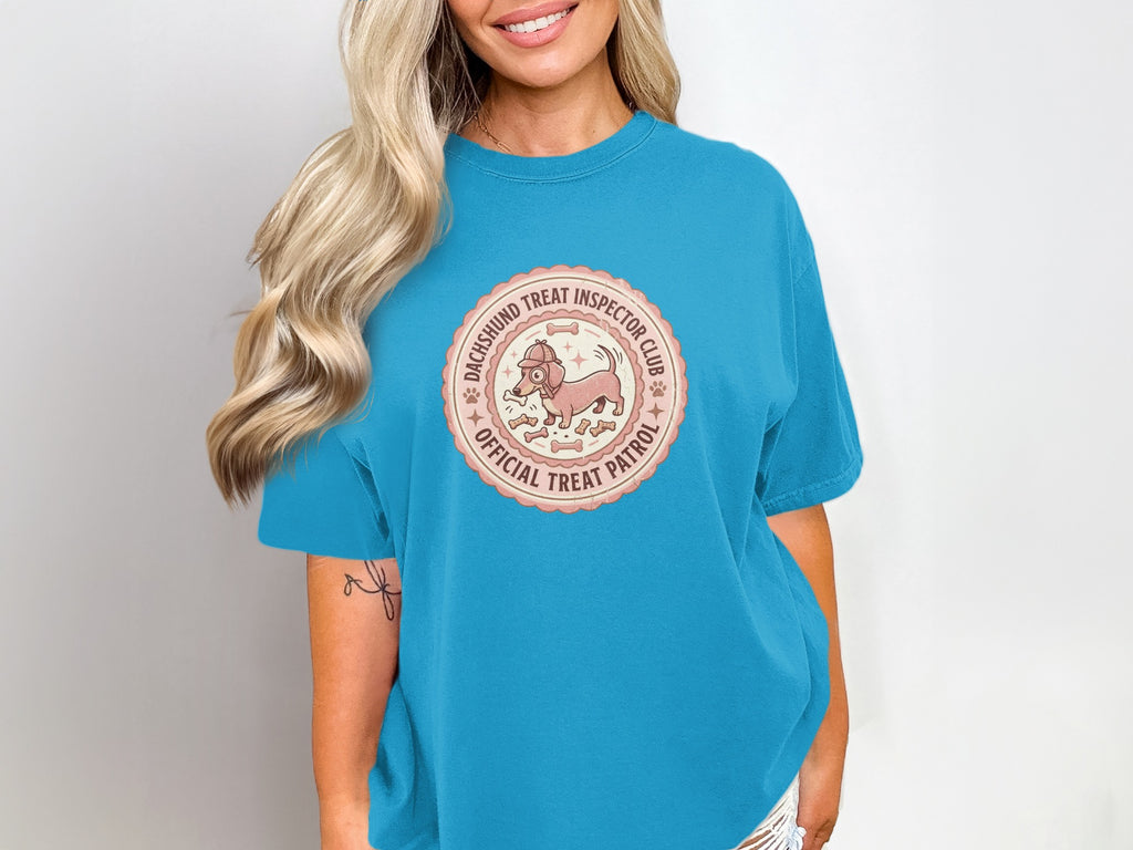Dachshund Treat Inspector Club Official Treat Patrol circular logo on a teal t-shirt.