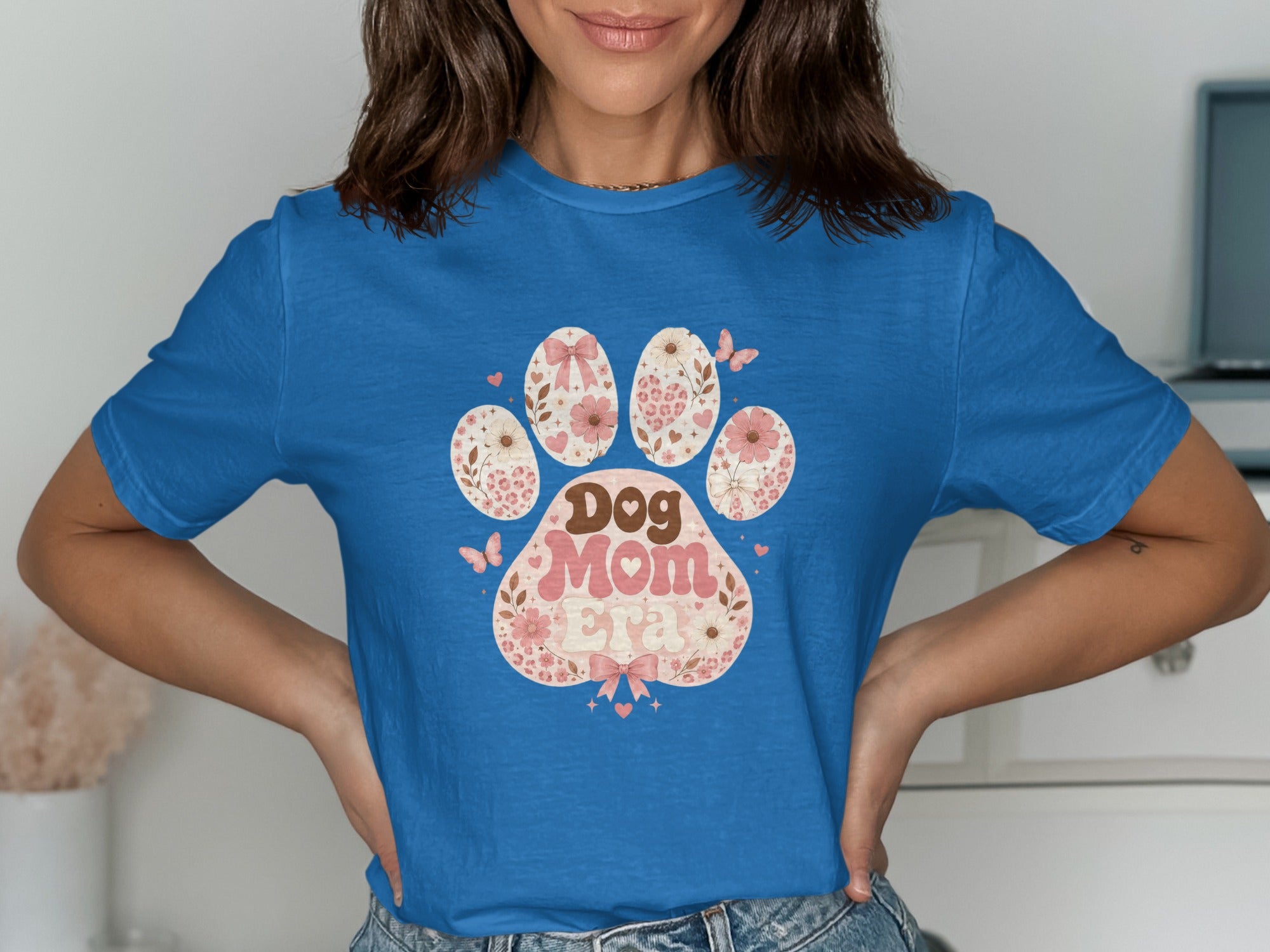 Blue t-shirt with a floral dog paw print design saying "Dog Mom".