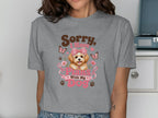 Woman wearing a gray t-shirt with a puppy graphic and "Sorry, I have plans with my dog" text.
