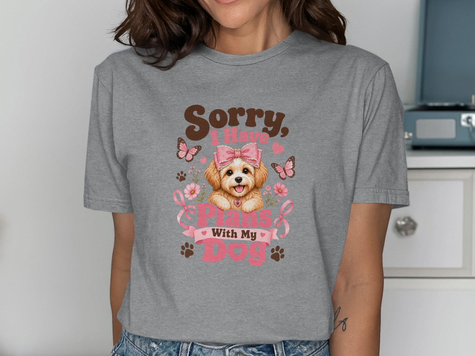 Woman wearing a gray t-shirt with a puppy graphic and "Sorry, I have plans with my dog" text.