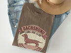 Brown t-shirt with Dachshund Long Dog Club logo featuring a dog silhouette.